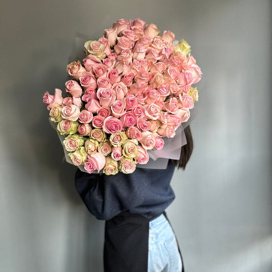 A luxurious bouquet of 101 baby pink roses, arranged in a lush, full display with soft, delicate petals and a sweet, feminine color palette.