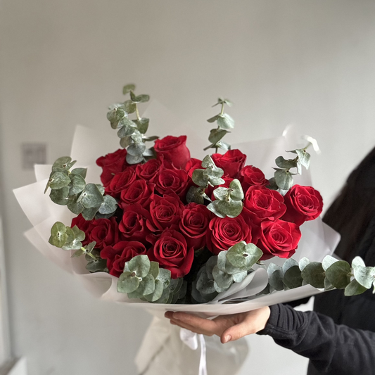 A Red Flames Rose Bouquet featuring deep red and fiery orange roses, arranged to create a dramatic, passionate floral display symbolizing love and desire.
