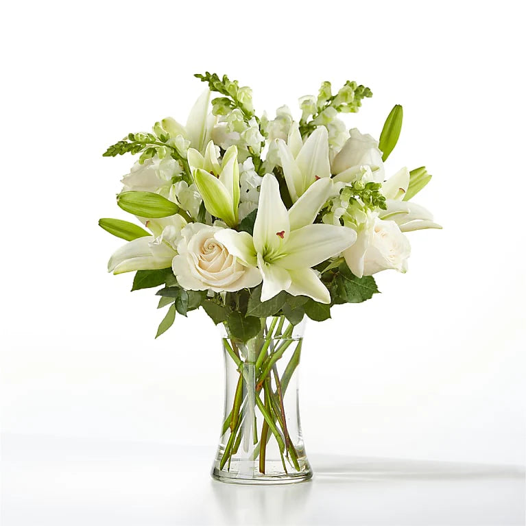 A Sympathy Flower Vase featuring soft, soothing flowers like lilies, roses, and chrysanthemums in pastel shades, offering a peaceful and respectful floral tribute.