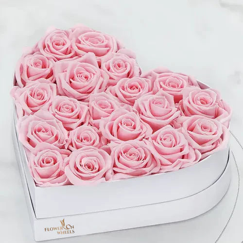 A luxurious arrangement of baby pink roses in a sleek, elegant box, symbolizing love and admiration. The soft pastel blooms are carefully arranged with a ribbon accent, offering a sophisticated and romantic touch.

