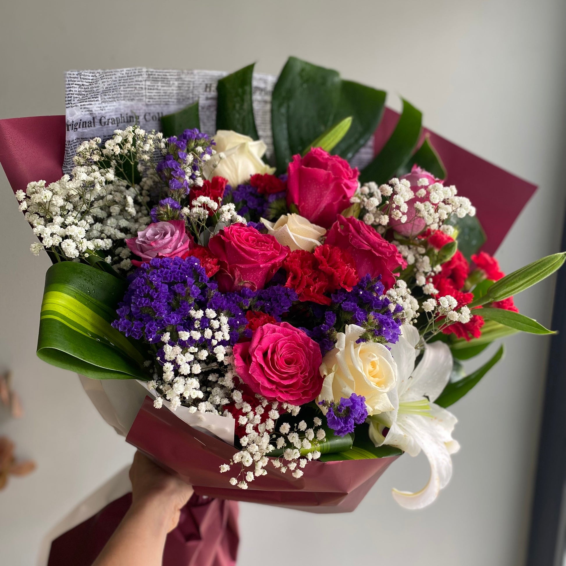 A vibrant birthday mix bouquet featuring an assortment of colorful flowers like roses, lilies, daisies, and carnations, arranged to celebrate a special occasion with cheer and joy.