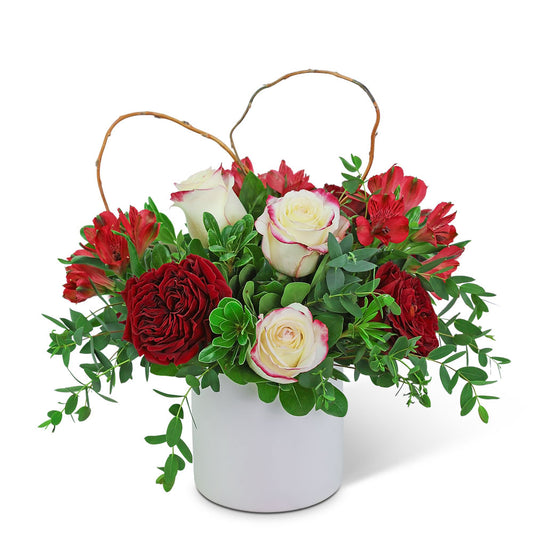 A charming Mini Mixed Flower Box featuring fragrant roses and lush greenery, elegantly arranged in a compact box for a thoughtful and romantic gift.

