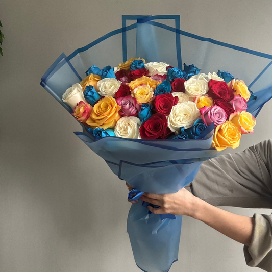 A stunning Minimalist 50 Colourful Roses arrangement, showcasing 50 vibrant roses in a simple, elegant design that highlights their lively and varied colors.

