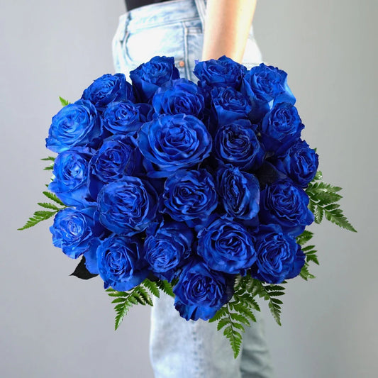 A minimalist Navy Blue Roses arrangement featuring deep blue roses arranged in a simple, elegant style that highlights their striking color and sophisticated beauty.

