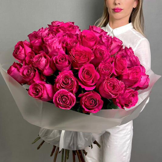 A minimalist Pink Floyd Roses arrangement featuring bold, deep pink roses with a subtle gradient, arranged in a clean, elegant style that highlights their striking color and creative beauty. 