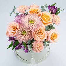 A Mixed Flower Box featuring a vibrant mix of fresh roses, lilies, tulips, and seasonal blooms arranged in a chic box, creating a joyful and colorful floral display. 