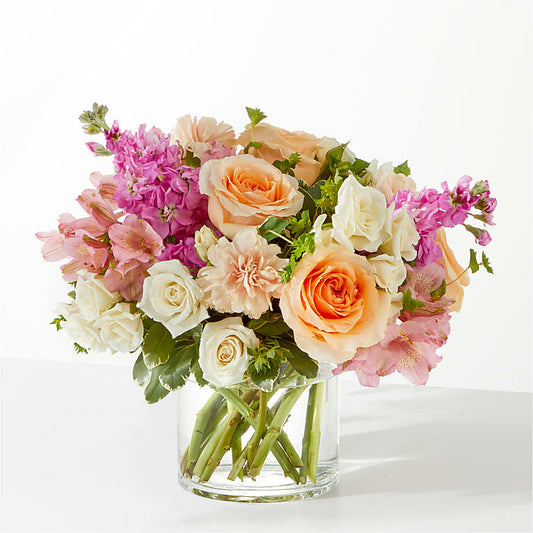 A Sympathy Flower Vase featuring soft, soothing flowers like lilies, roses, and chrysanthemums in pastel shades, offering a peaceful and respectful floral tribute.